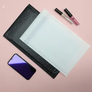 Black and pale padded mailers beside small retail items