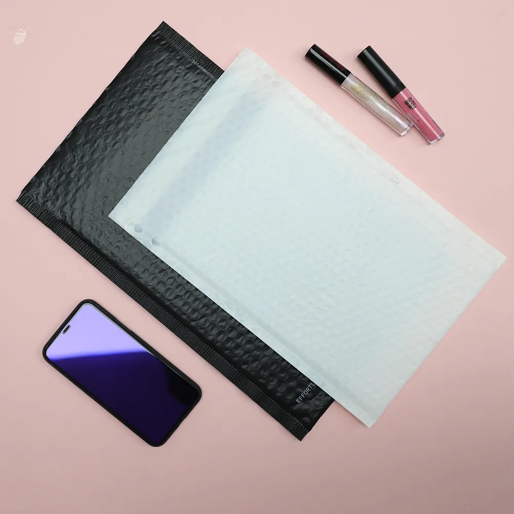 Black and pale padded mailers beside small retail items
